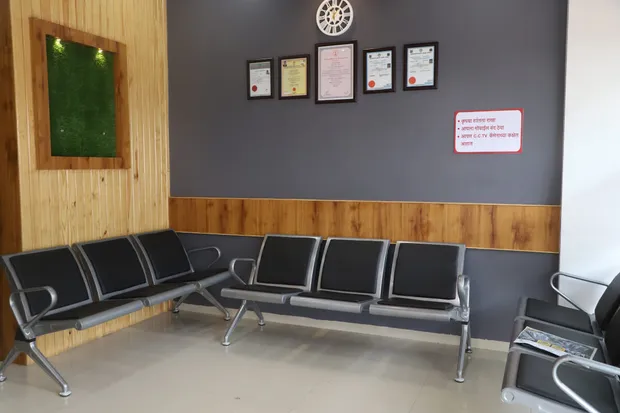 Patient waiting area with framed accreditations at Sangolkar Heart Care Center